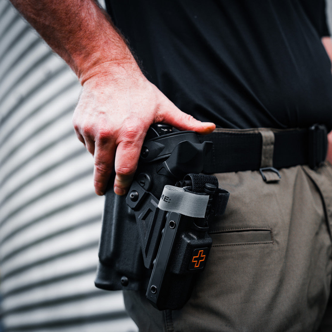 Pistol holster mount for tourniquet carrier. Tourniquet mounting bracket for Safariland SLS / ALS holsters. Red dot and non-red dot sight models. Red dot and non-red dot sight models. Eleven 10 RIGID TQ Case Holster Mount.